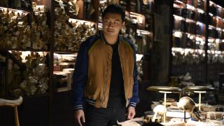 Simu Liu surrounded by antiques in Shang-Chi and the Legend of the Ten Rings