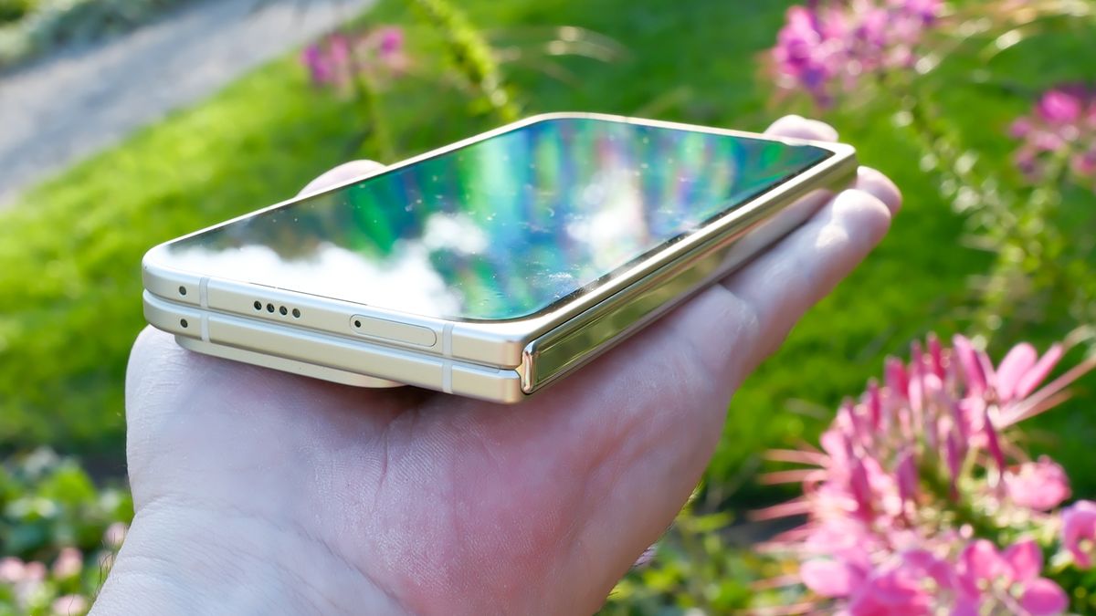 Google Pixel 10 Pro Fold in Jade green outside at a flower garden on a sunny day