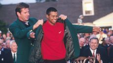 Tiger Woods receives the Green Jacket from Nick Faldo after winning the 1997 Masters