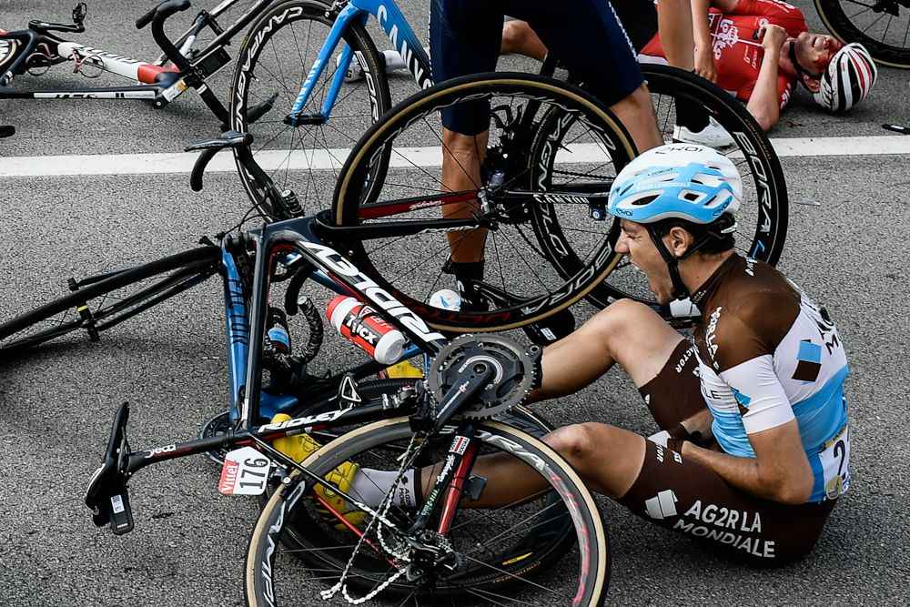 Axel Domont grimaces after being caught in a massive pack fall in the last kilometers of the fourth stage of the 105th edition of the Tour de France