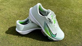 Nike Air Zoom Infinity Tour Next% 2 Golf Shoes resting on course