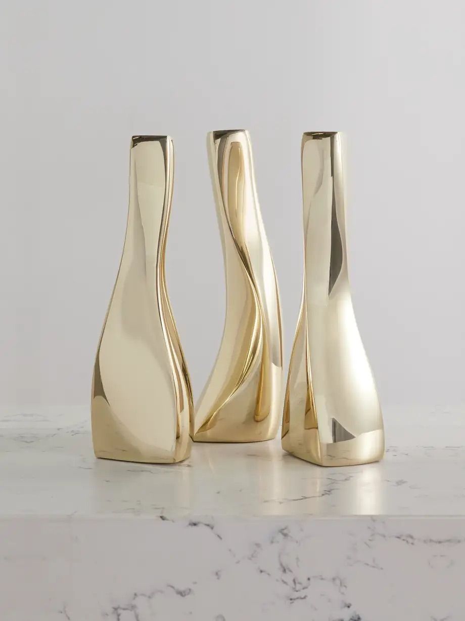 FOURTH STREET Set of three gold-tone candlesticks