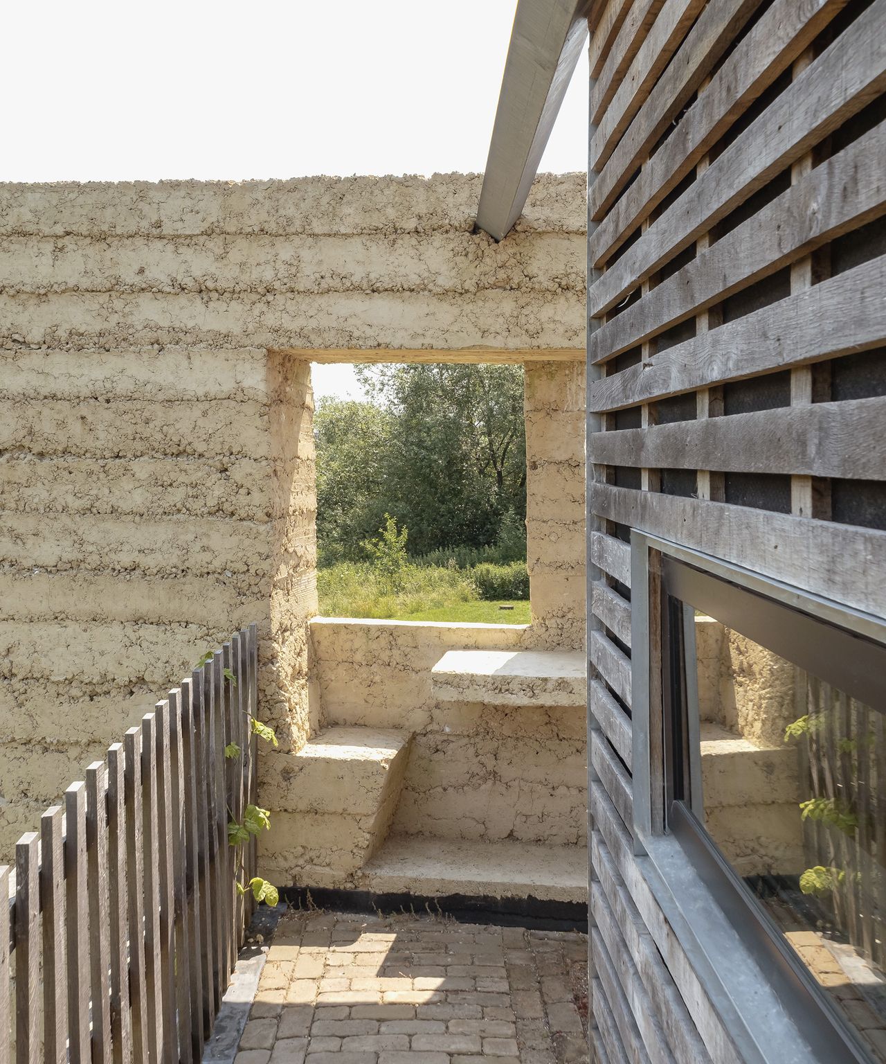 A seating area built into a garden wall made from reclaimed build materials