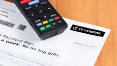 UK TV licence bill on desk with remote control on top