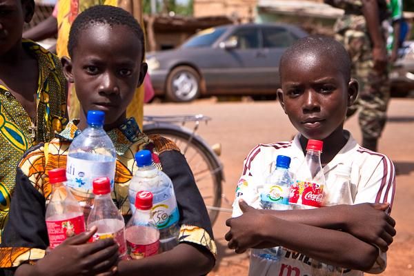 Youngsters gather water bottles discarded by the race. These containers sell in local markets for 25-50 CFA ( approximately 5-10 US cents).