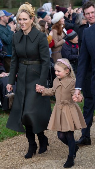 Zara Tindall holds the hand of her daughter Lena Tindall as they attend the Christmas Day service at St Mary Magdalene Church on December 25, 2023