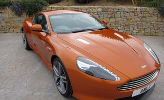 Orange coloured Aston martin virage Jt