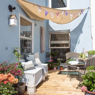 terrace with bunting cushion and blue wall