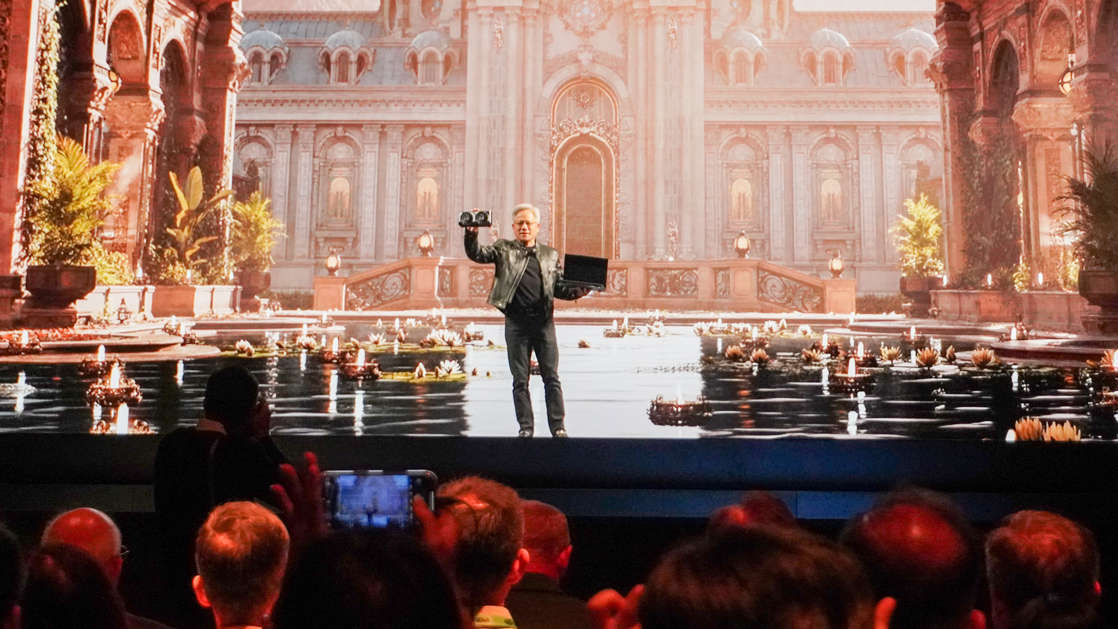 Nvidia CEO Jensen Huang at Computex 2025 Nvidia keynote holding RTX 5060 and MSI laptop