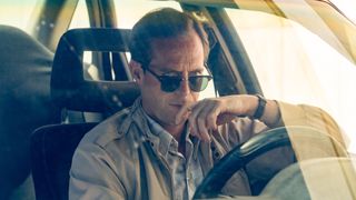 Lundy sits in a car in The Gold season 2