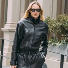 A women wears a leather jacket during fashion week.