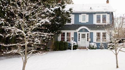 A blue house in thick snow