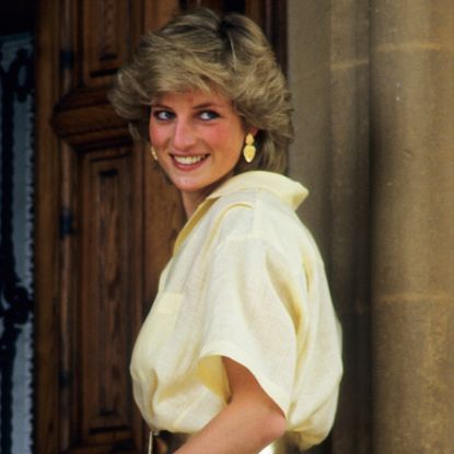 Princess Diana wearing a pale yellow blouse and matching earrings