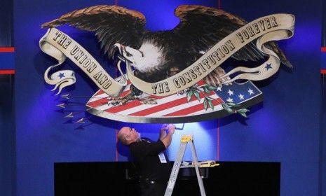 A production crew adjusts lighting ahead of Thursday&amp;#039;s vice presidential debate.