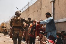 U.S. Marine hands out water at Kabul airport