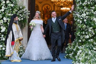 Princess Theodora of Greece and her husband Matthew Kumar smile and greet the crowd as they leave their wedding ceremony at the Metropolis Greek Orthodox Cathedral on September 28, 2024