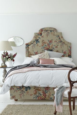 French style bedroom with floral headboard and striped sheets