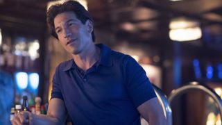 Jon Bernthal as Julian Kaye at a bar in American Gigolo