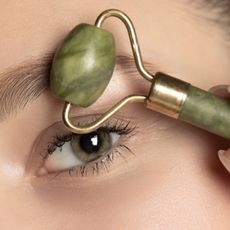 woman using a jade eye roller