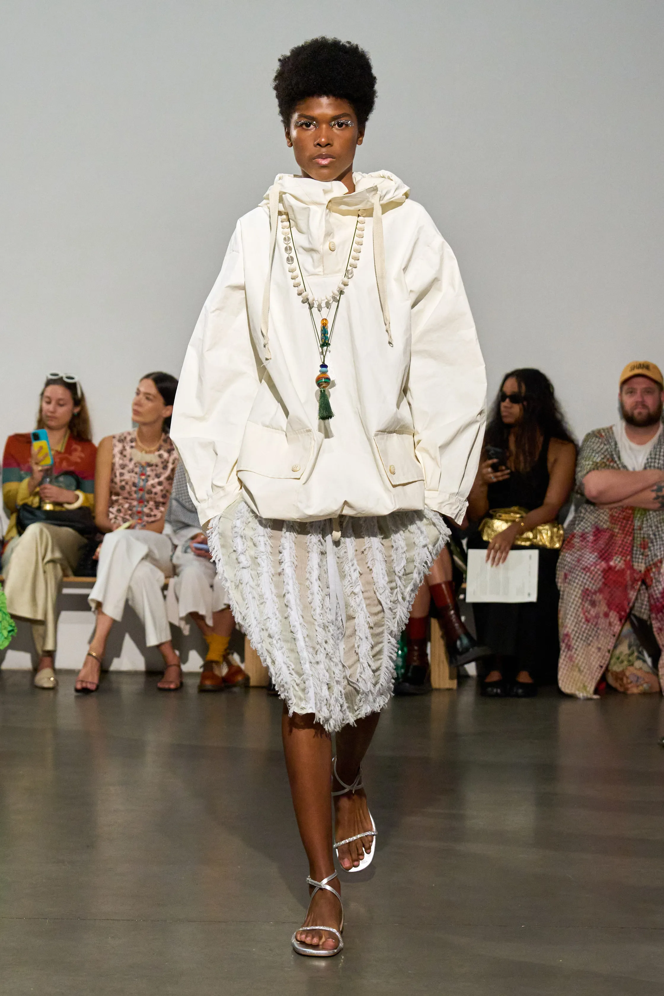 Zankov Spring 2026 runway, woman wearing white windbreaker and white skirt