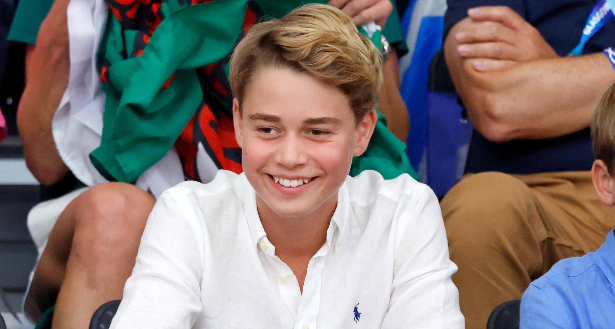 Prince George smiling in a white button up shirt