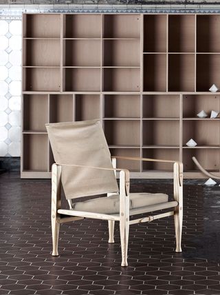 Image of a chair with wooden unit behind