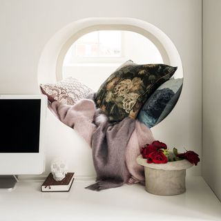 gothic theme dark floral print and lacy cushions with pink and lavender throws
