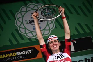 TOPSHOT UAE Team Emirates teams Slovenian rider Tadej Pogacar celebrates on the podium after winning the 116th edition of the Giro di Lombardia Tour of Lombardy a 25242 km cycling race from Bergamo to Como in Como on October 8 2022 Photo by Marco BERTORELLO AFP Photo by MARCO BERTORELLOAFP via Getty Images