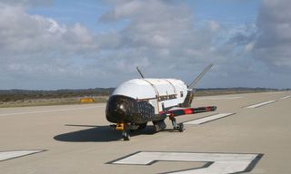 The X-37B space plane prototype is seen on a runway during flight tests in this undated photo released by the U.S. Air Force.