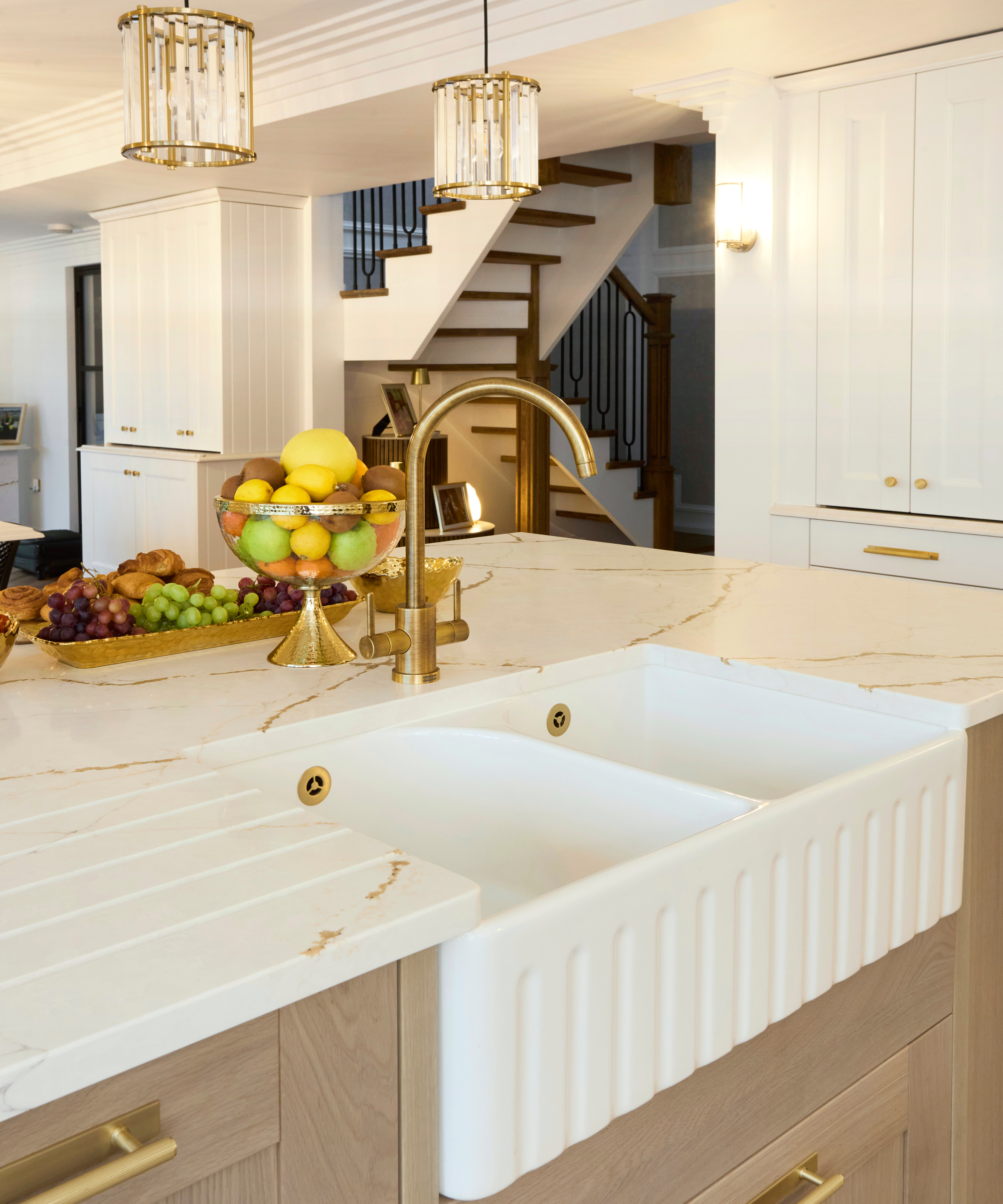 large kitchen island with double white butler sink inset into island