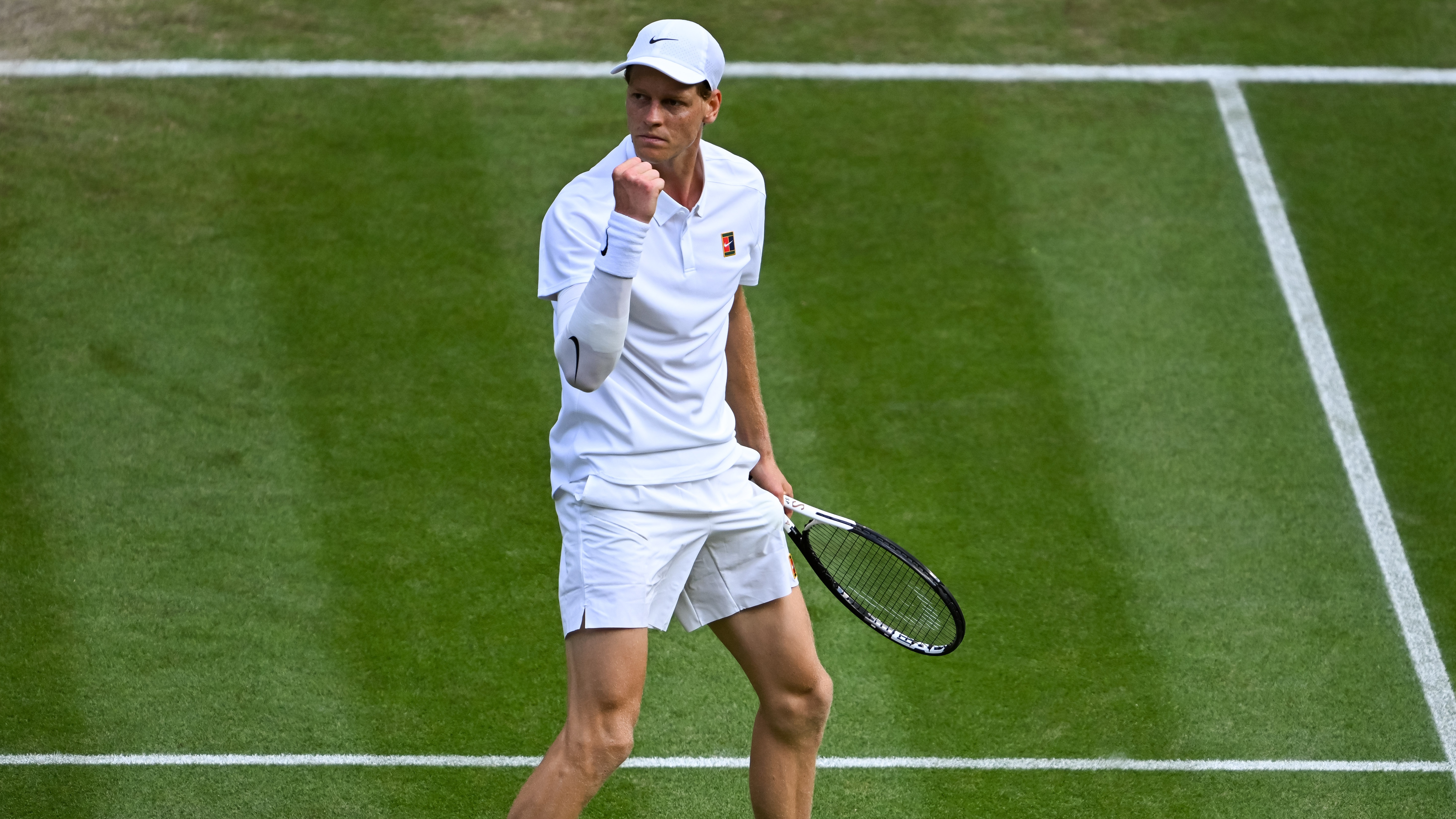Jannik Sinner celebrates winning a point against Ben Shelton.