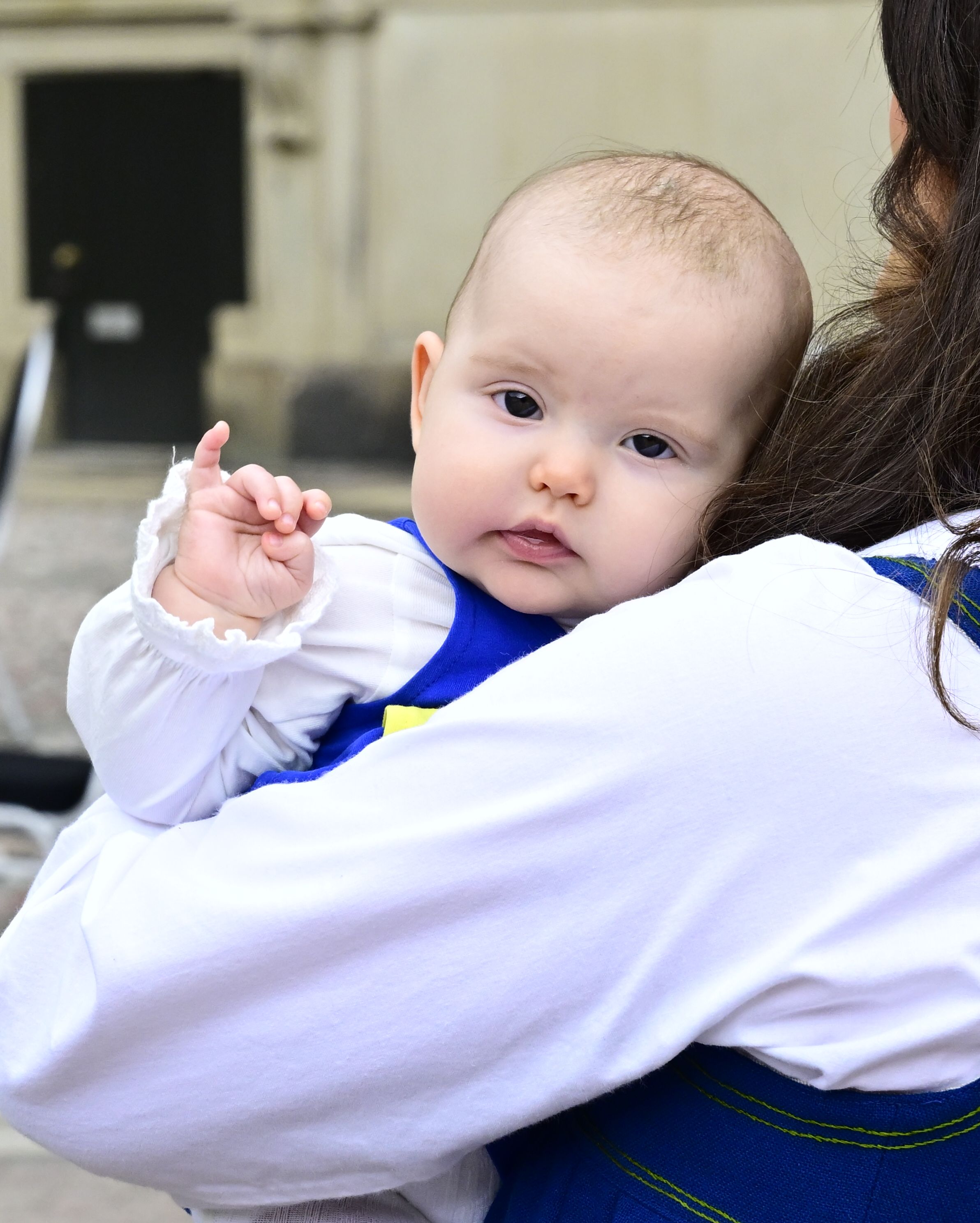 Princess Ines looking at the camera being held by Princess Sofia