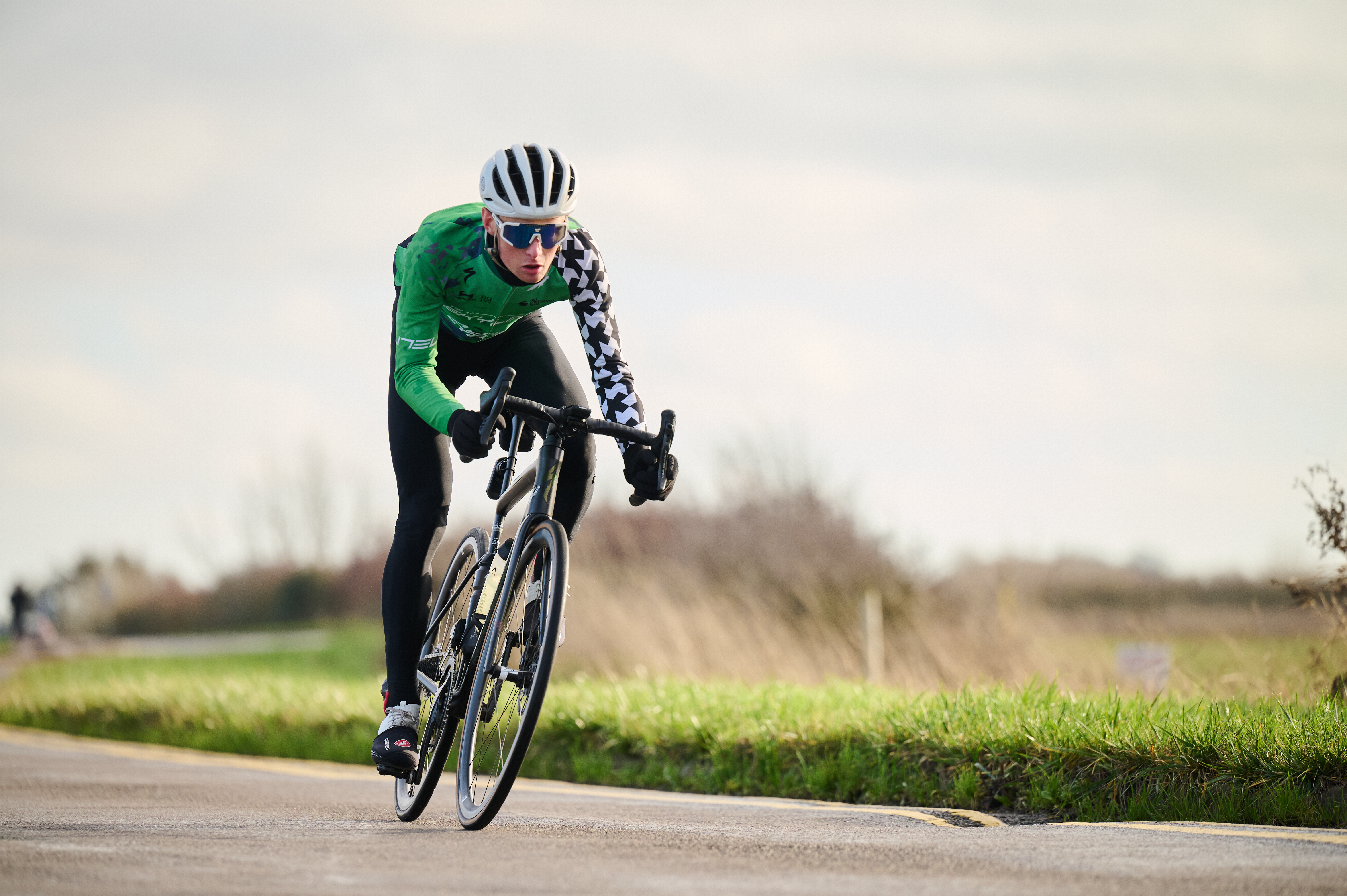 Man cycles along a flat road