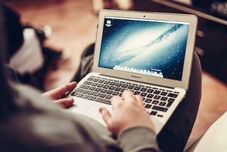 Student with a laptop engaging in AI-enhanced deeper learning