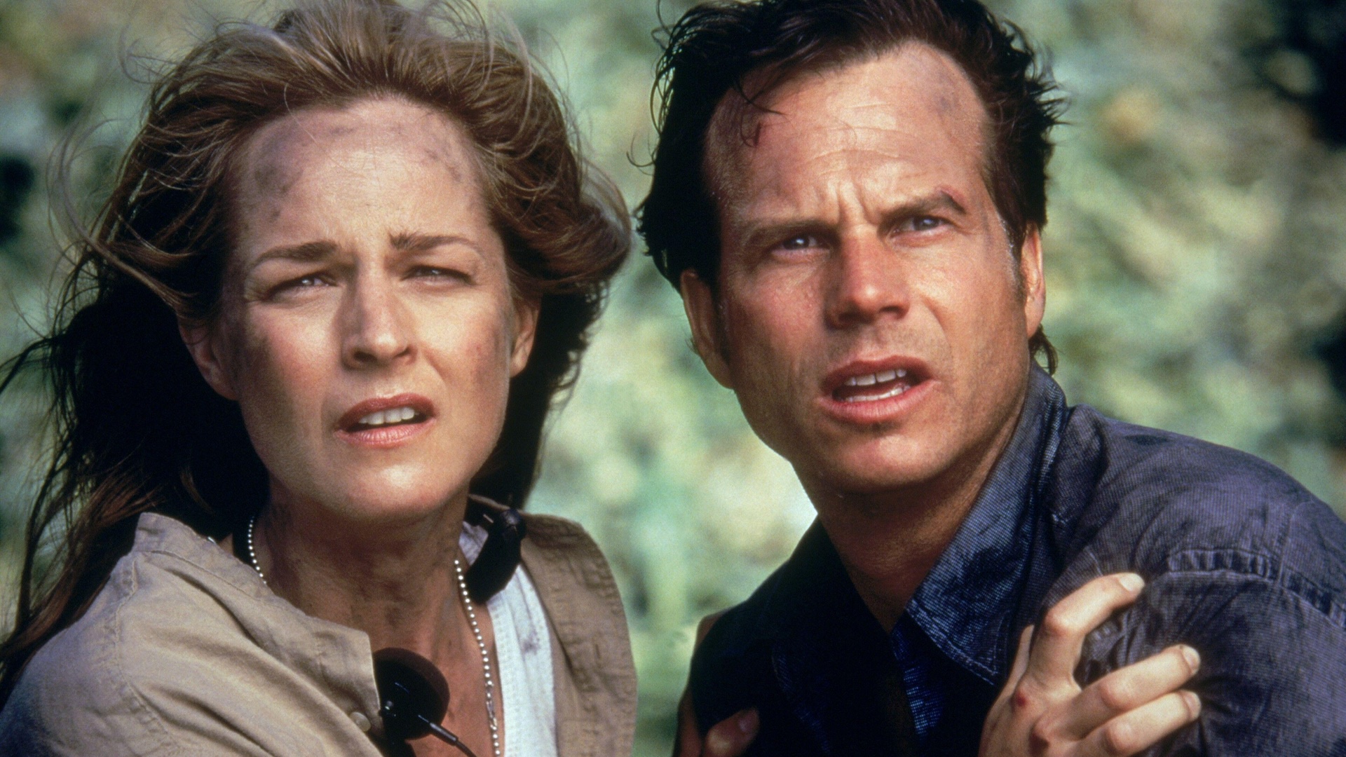 A still of Helen Hunt gripping Bill Paxton while they are both covered in dirt