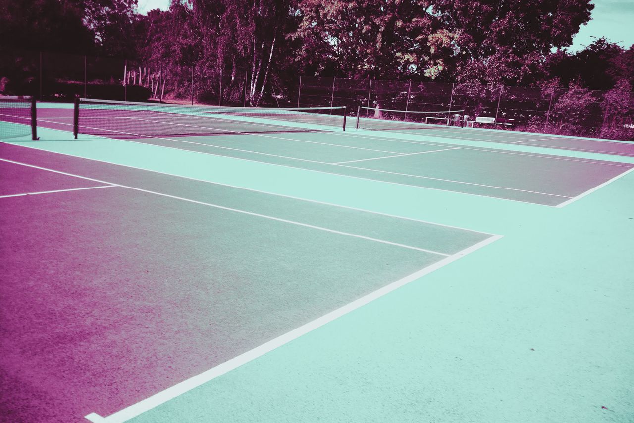 Photograph taken with the RewindPix digital compact showing a tennis court with highly stylised purple tones