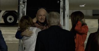 NASA astronaut Scott Kelly hugs his daughters in Houston on March 3, 2016, after coming home from a 340-day mission aboard the International Space Station.