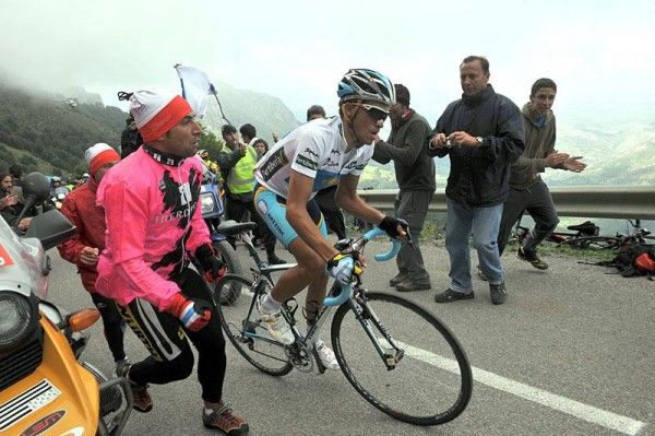 Fans run alongside Contador on the steep part of the climb