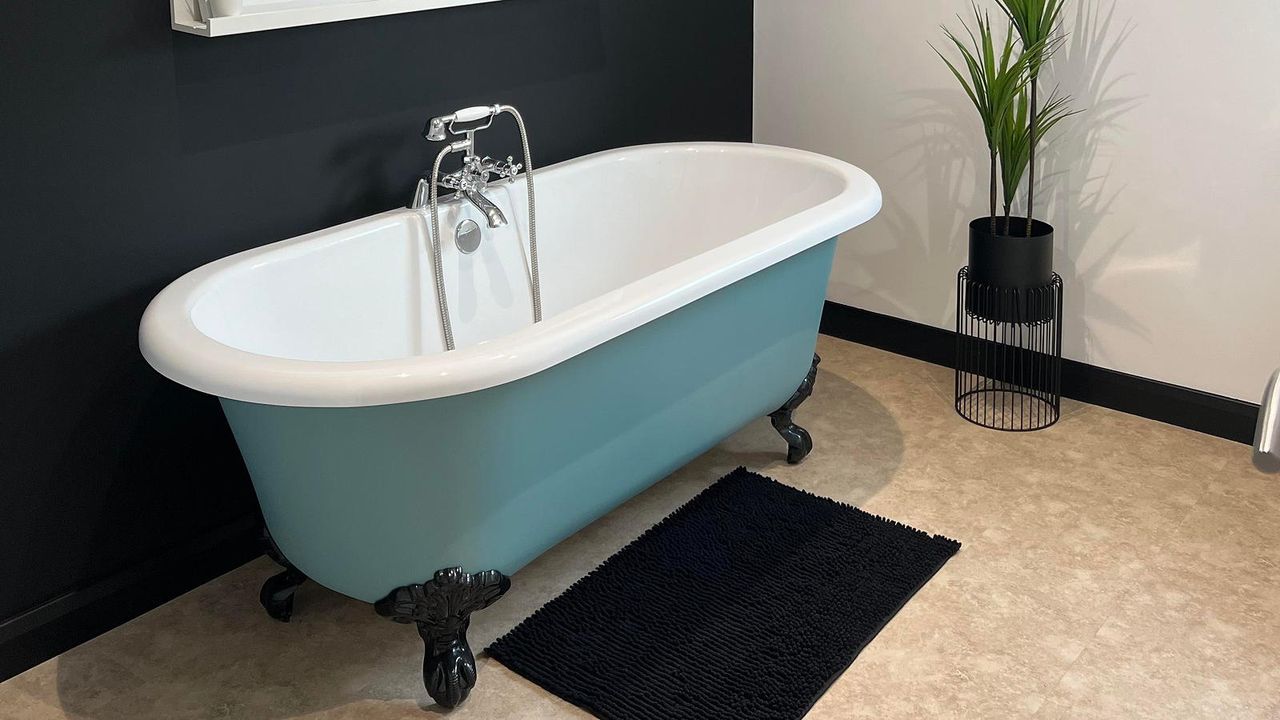 bathroom with blue roll top bath