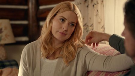 Mel looks at Jack from across the sofa