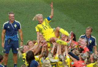 Caroline Seger being lifted by her teammates