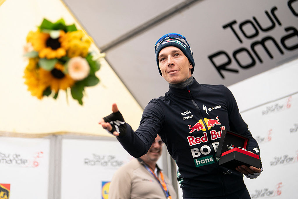 Second placed Red Bull BORA hansgrohe's German Florian Lipowitz, throws flowers during the podium ceremony of the final stage of the Tour of Romandie UCI cycling World tour, 178.2 km from Lucens and to Leysin, in Leysin, Switzerland, on May, 3, 2026. (Photo by TIL BUERGY / AFP via Getty Images)