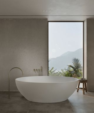 Minimalist bathroom with grey concrete walls and freestanding tub