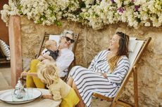 Grandmother, mother and kids relax on a family vacation.