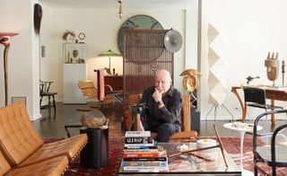 George Lois, trying out the Apple Watch Hermès, surrounded by his design collection in his New York apartment.