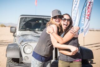 Two women in front of Jeep at end of rally