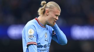 Manchester City striker Erling Haaland holds his head during his side's 3-1 win over Aston Villa in the Premier League in February 2023.