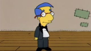 Screenshot of Milhouse in tux on stage in The Simpsons