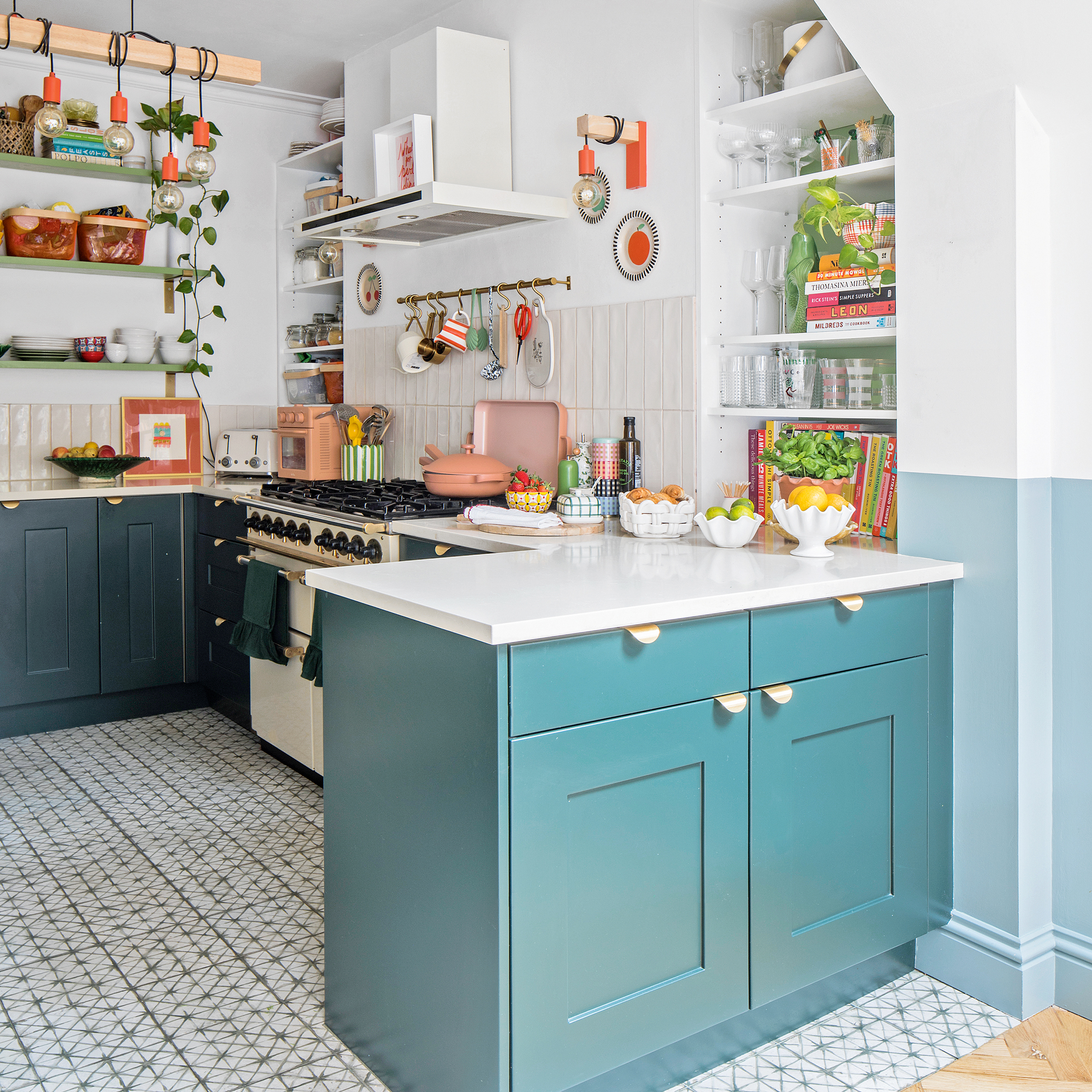 a kitchen with neutral wall tiles, blue painted cabinetry and open shelving
