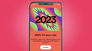 An iPhone on a pink background showing the Spotify Wrapped 2023 teaser